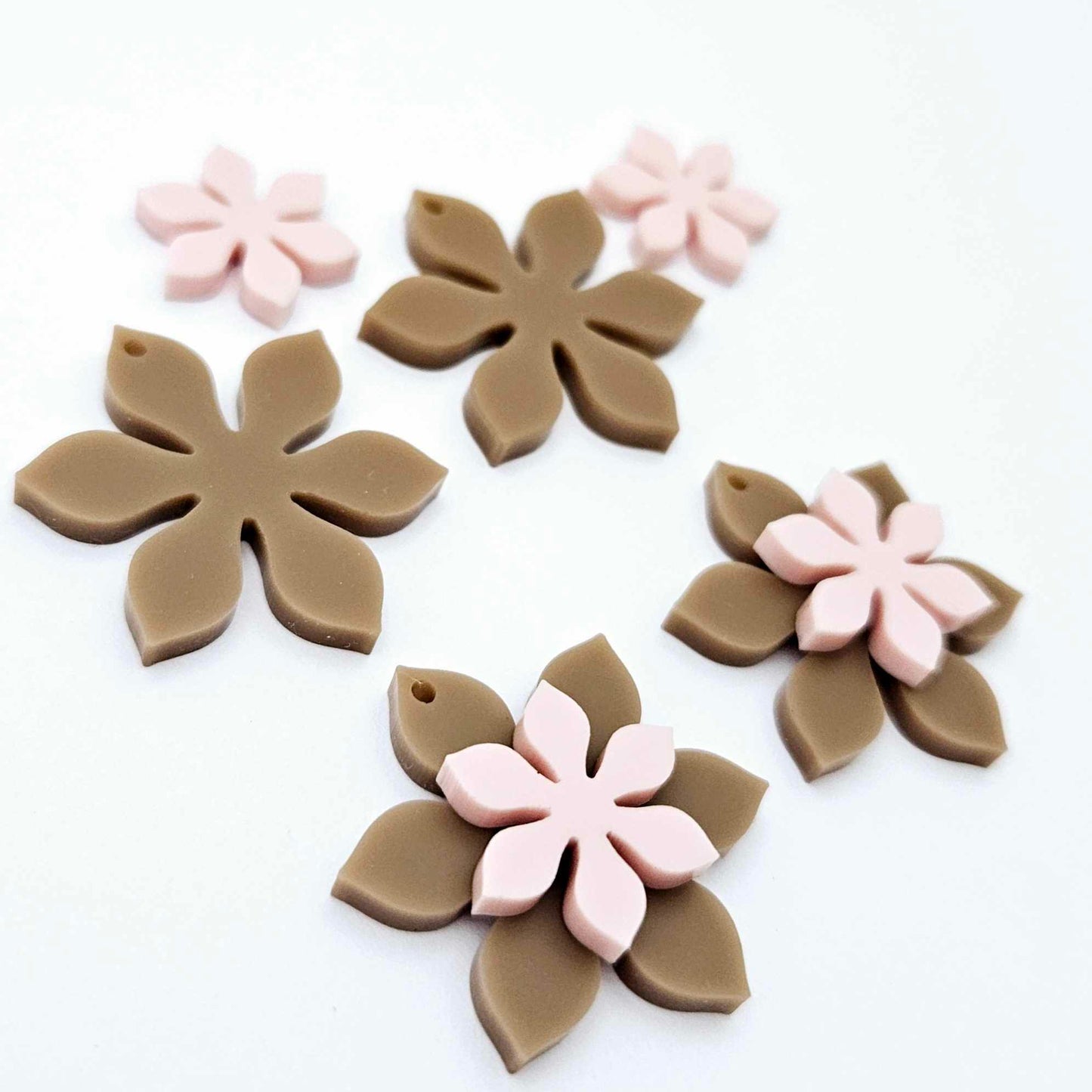 Iced Coffee Brown and strawberry milkshake pink acrylic two layer flower dangle blanks shown laying flat, with some flowers stacked to show layered effect and others positioned side by side