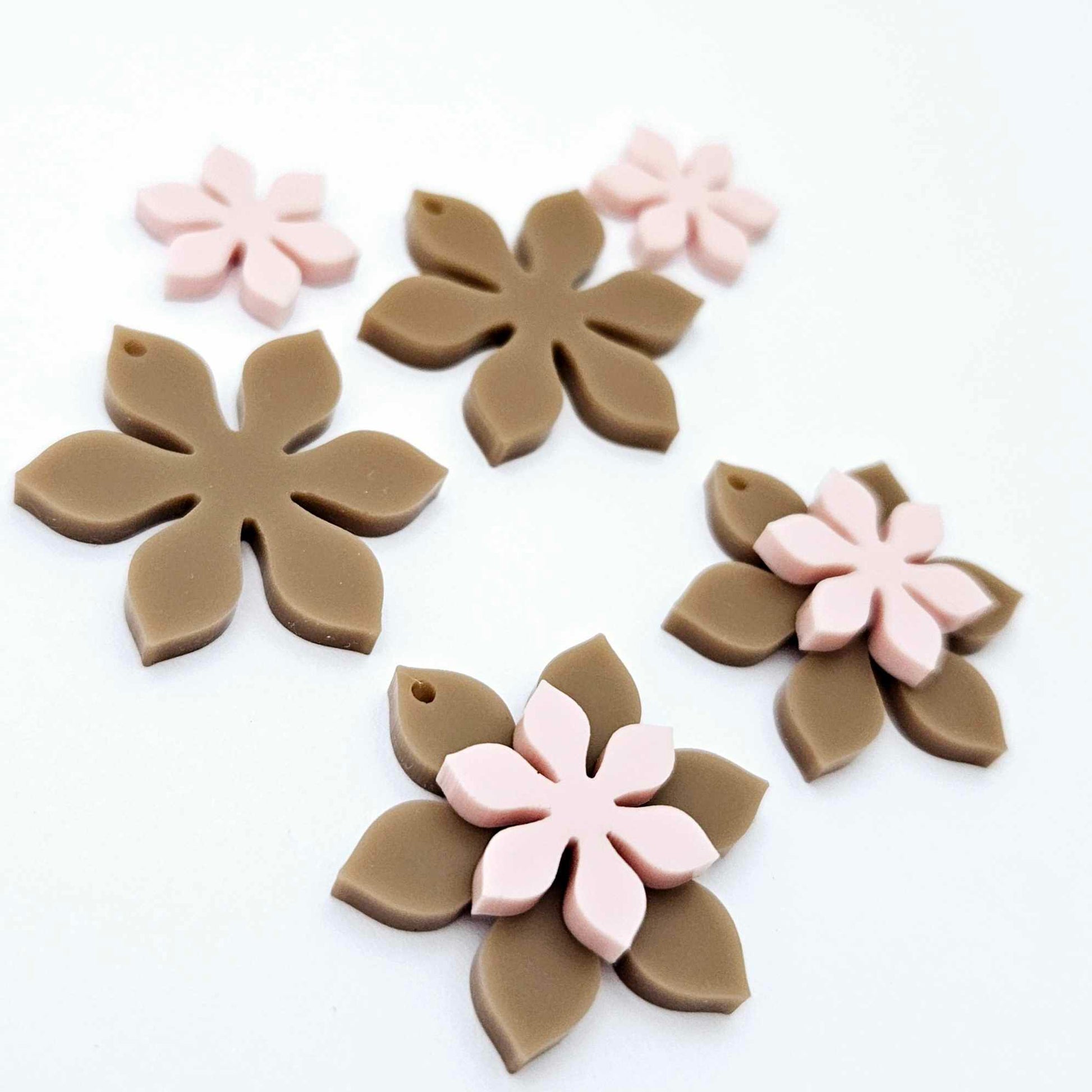 Iced Coffee Brown and strawberry milkshake pink acrylic two layer flower dangle blanks shown laying flat, with some flowers stacked to show layered effect and others positioned side by side
