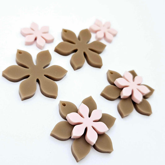 Iced Coffee Brown and strawberry milkshake pink acrylic two layer flower dangle blanks shown laying flat, with some flowers stacked to show layered effect and others positioned side by side