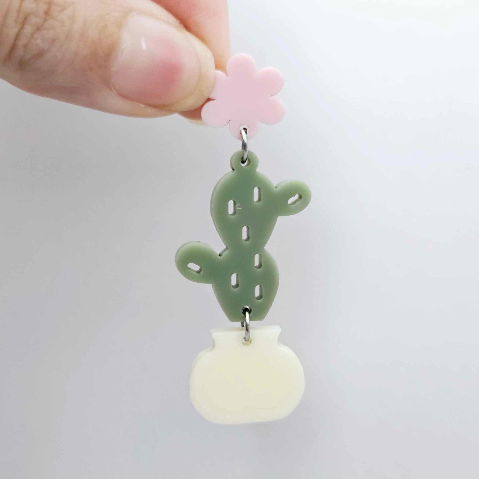 Assembled olive green acrylic cactus and cream pot dangle hanging from a 14mm strawberry milkshake flower topper
