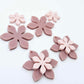 Dusty rose and strawberry milkshake two layer flower dangle blanks shown laying flat, with some flowers stacked to show layered effect and others positioned side by side