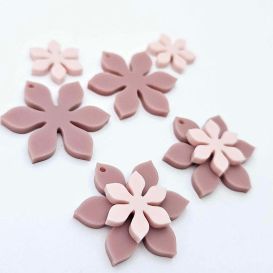 Dusty rose and strawberry milkshake two layer flower dangle blanks shown laying flat, with some flowers stacked to show layered effect and others positioned side by side