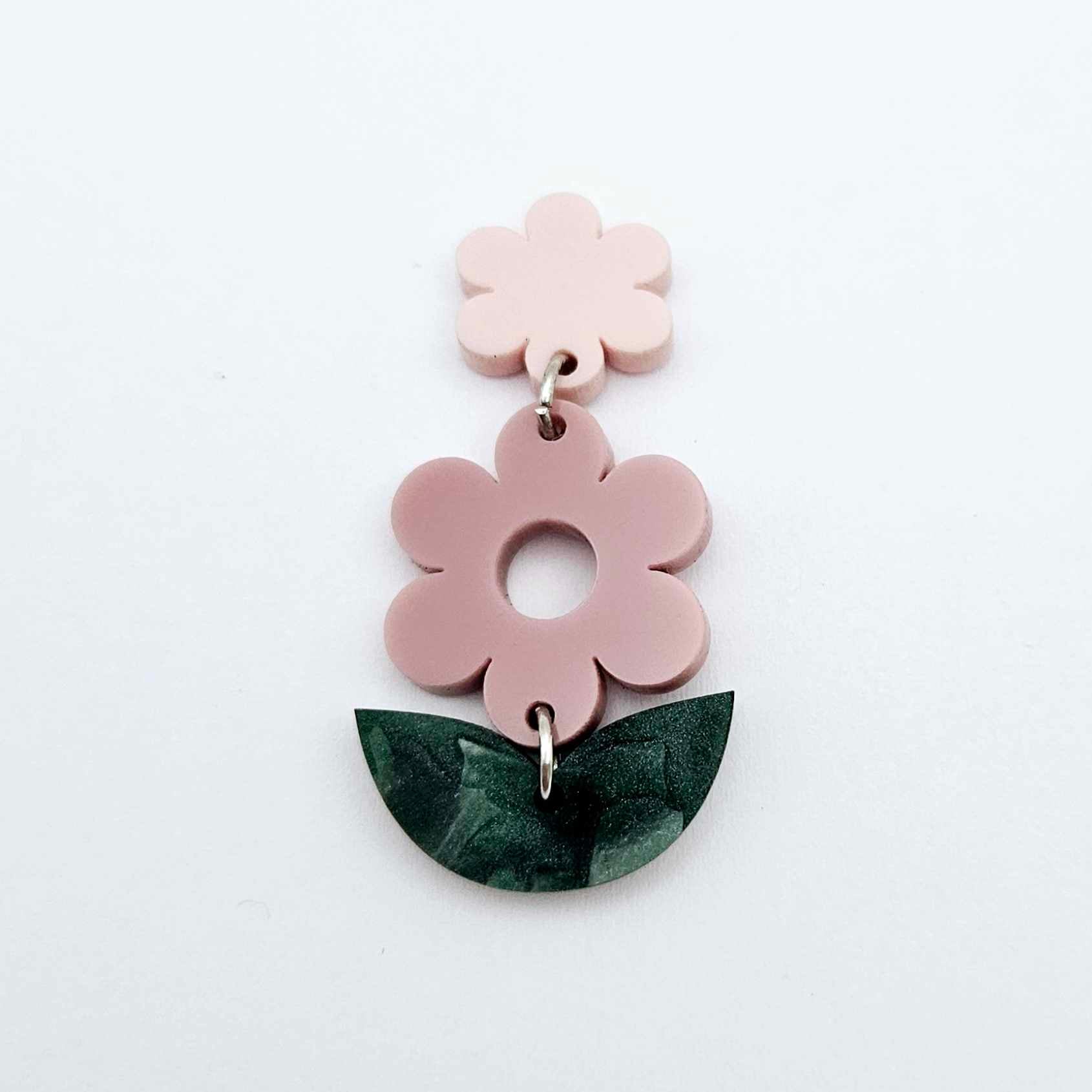 Assembled dusty rose and green mineral acrylic flower dangles hanging from strawberry milkshake flower toppers, layered botanical earring design
