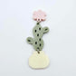 Assembled olive green acrylic cactus and cream pot dangle hanging from a 14mm strawberry milkshake flower topper