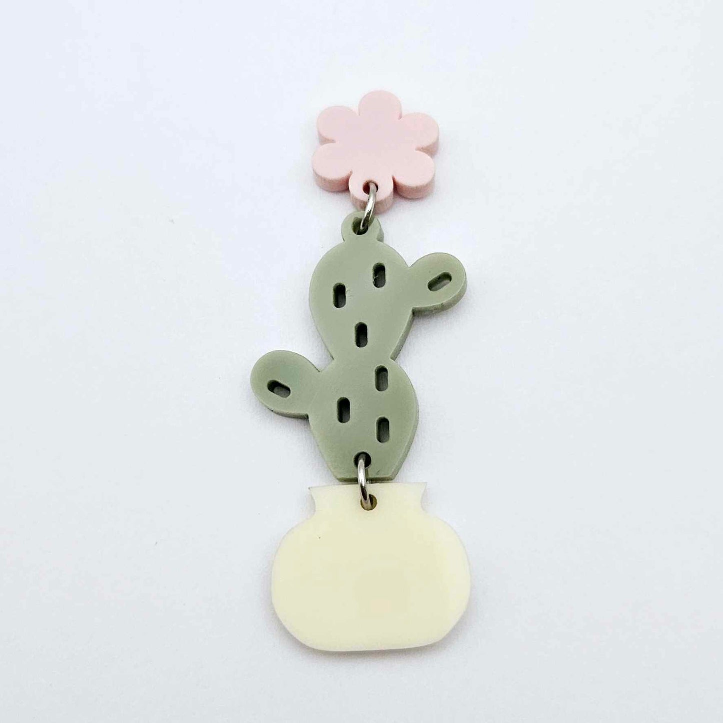 Assembled olive green acrylic cactus and cream pot dangle hanging from a 14mm strawberry milkshake flower topper