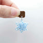 Layered blue gingham UV print and pastel blue acrylic flower dangle assembled and hanging from a 12mm walnut wood topper, 3D two tone floral design