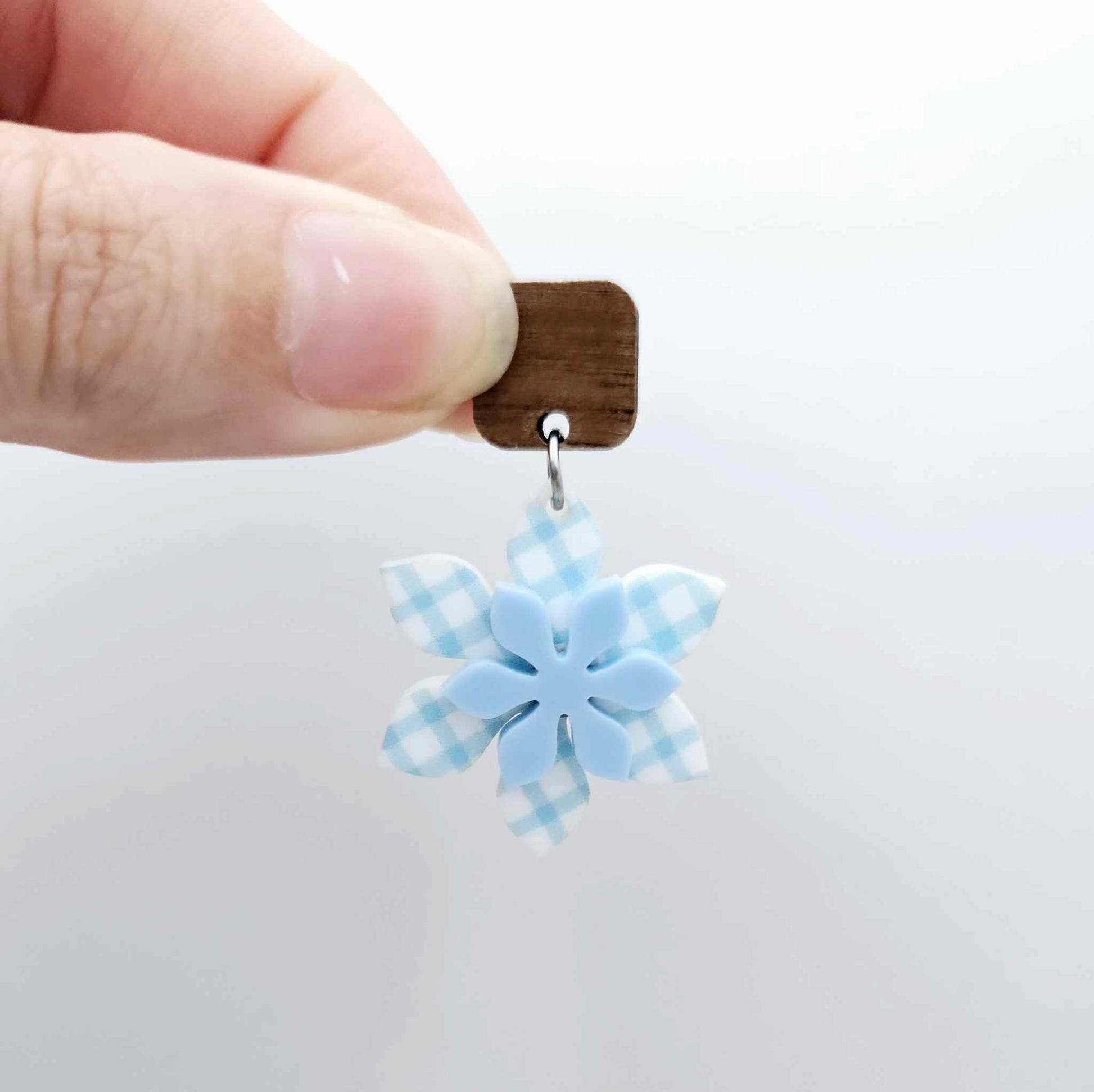 Layered blue gingham UV print and pastel blue acrylic flower dangle assembled and hanging from a 12mm walnut wood topper, 3D two tone floral design
