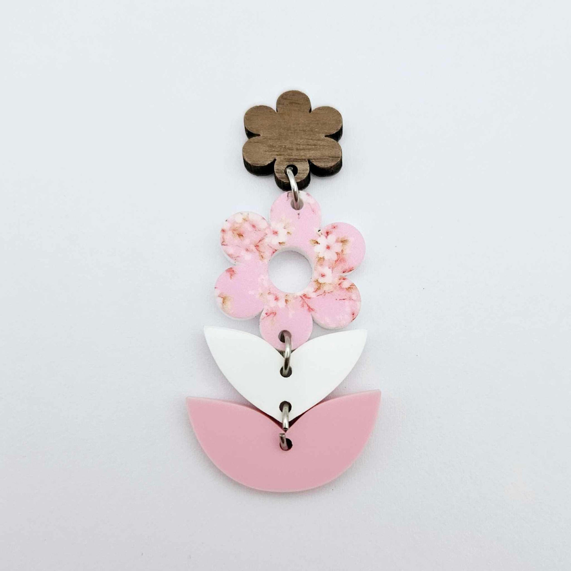 Assembled three-piece acrylic floral dangle hanging from a 14mm walnut flower topper, Cherry Blossom UV printed flower with white and pastel pink layered leaf pieces