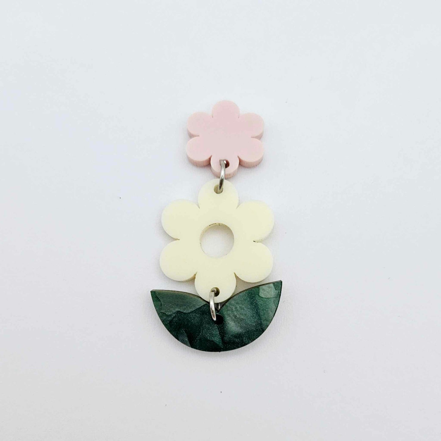Assembled cream and green mineral flower dangles hanging from strawberry milkshake flower toppers, layered botanical earring design