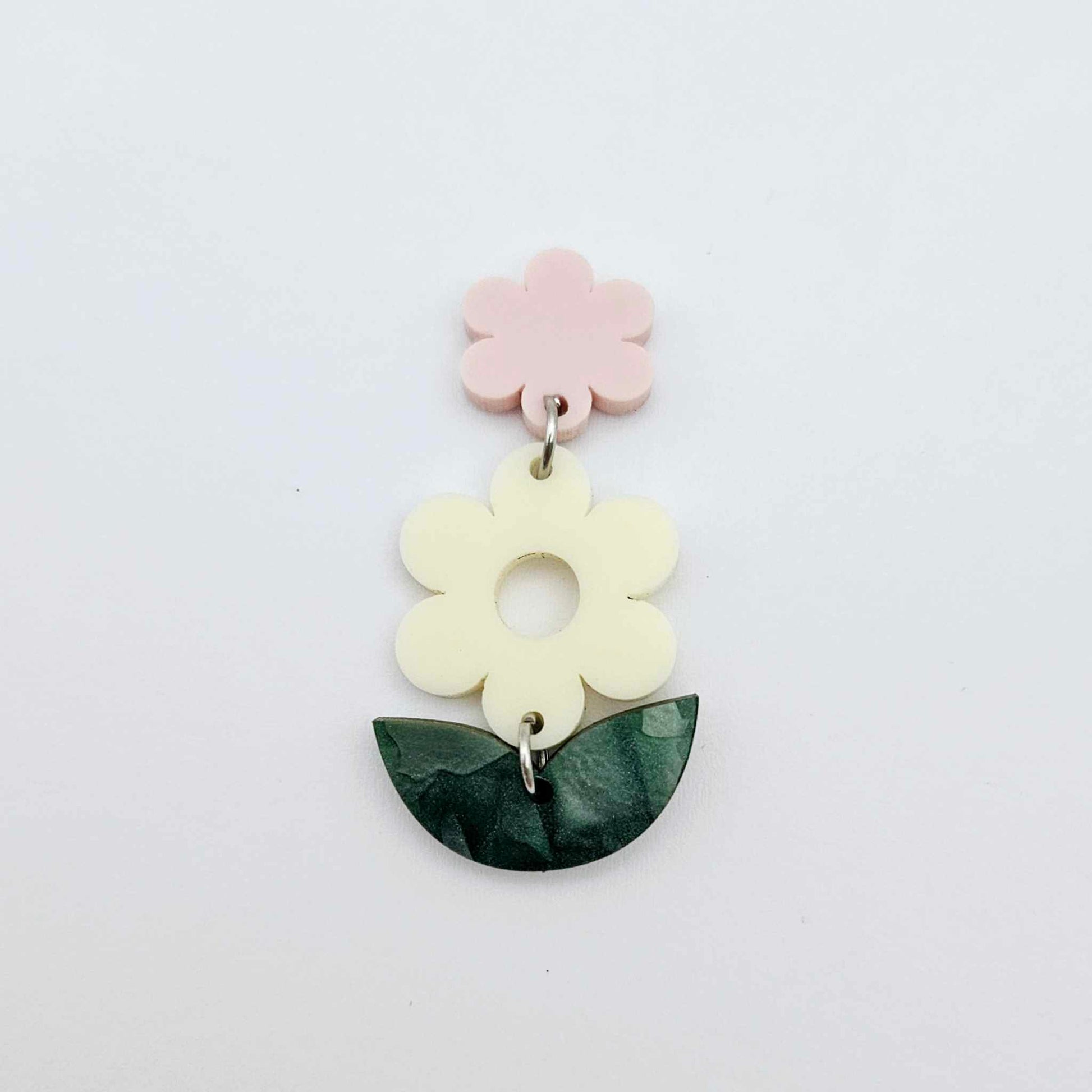 Assembled cream and green mineral flower dangles hanging from strawberry milkshake flower toppers, layered botanical earring design