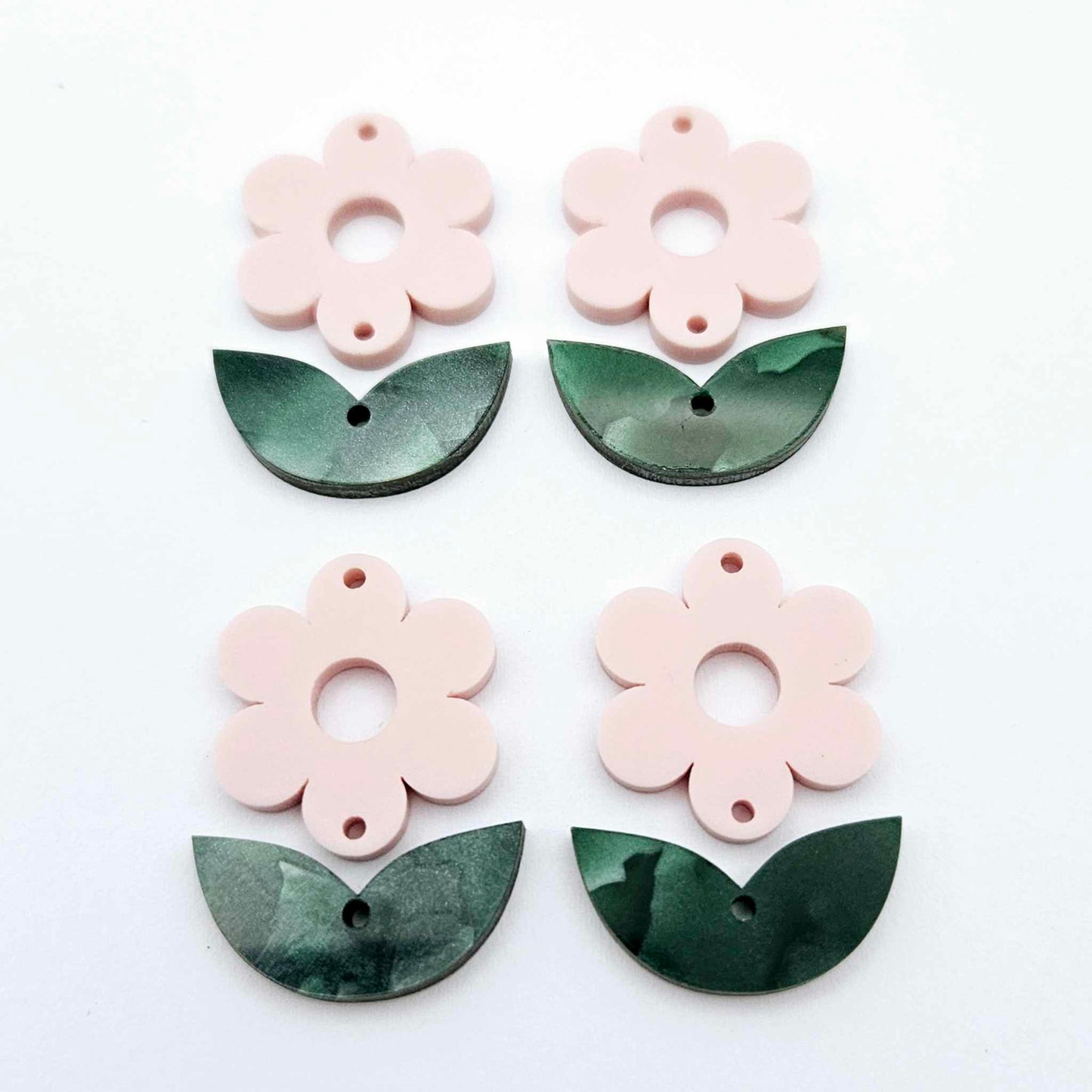 Two-piece Strawberry Milkshake pink flower and green mineral acrylic leafy dangle blanks shown unassembled and laying flat to display the full 31mm floral design