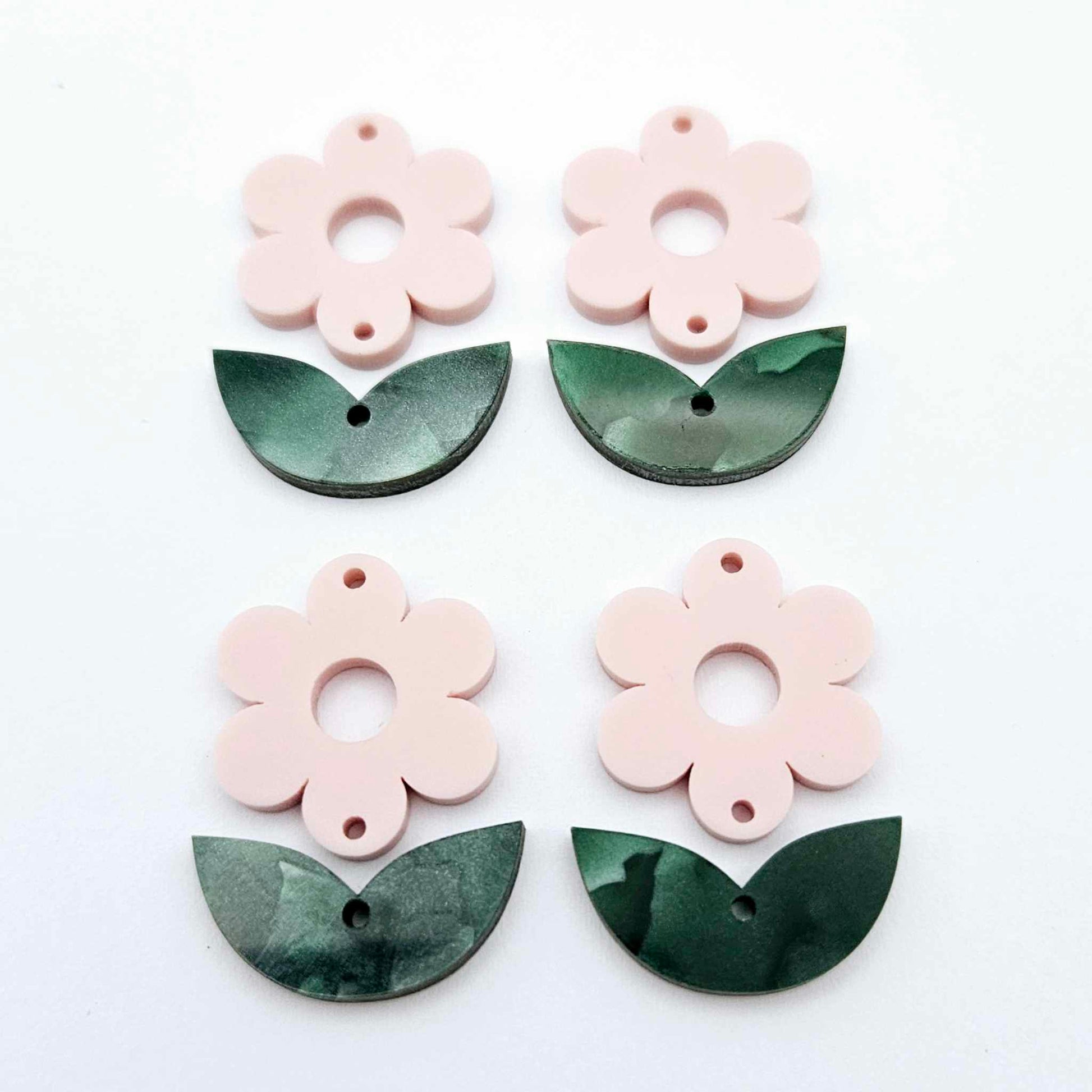 Two-piece Strawberry Milkshake pink flower and green mineral acrylic leafy dangle blanks shown unassembled and laying flat to display the full 31mm floral design