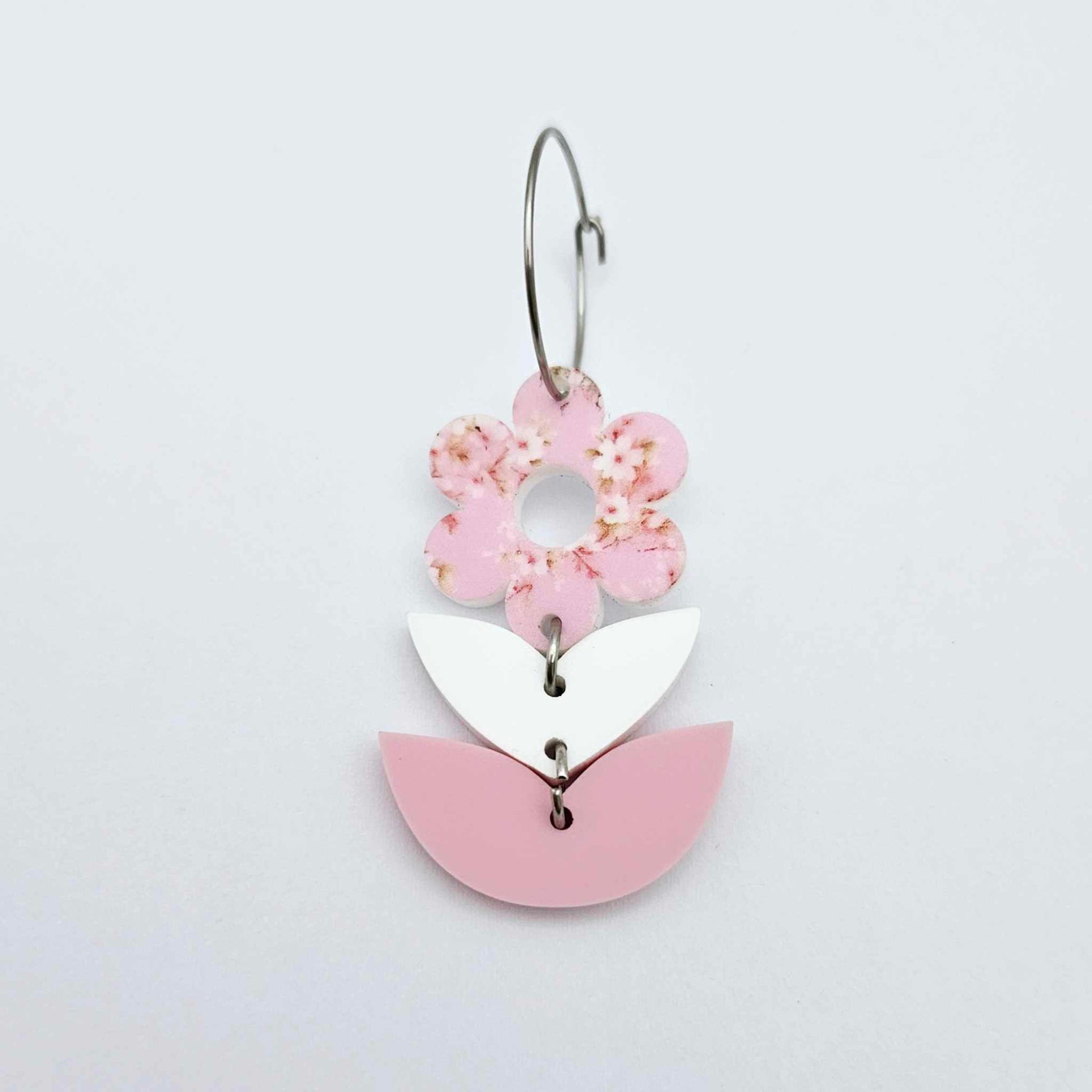 Assembled three-piece acrylic flower dangle hanging from a 20mm hoop, UV printed Cherry Blossom flower with white and pastel pink leaf layers