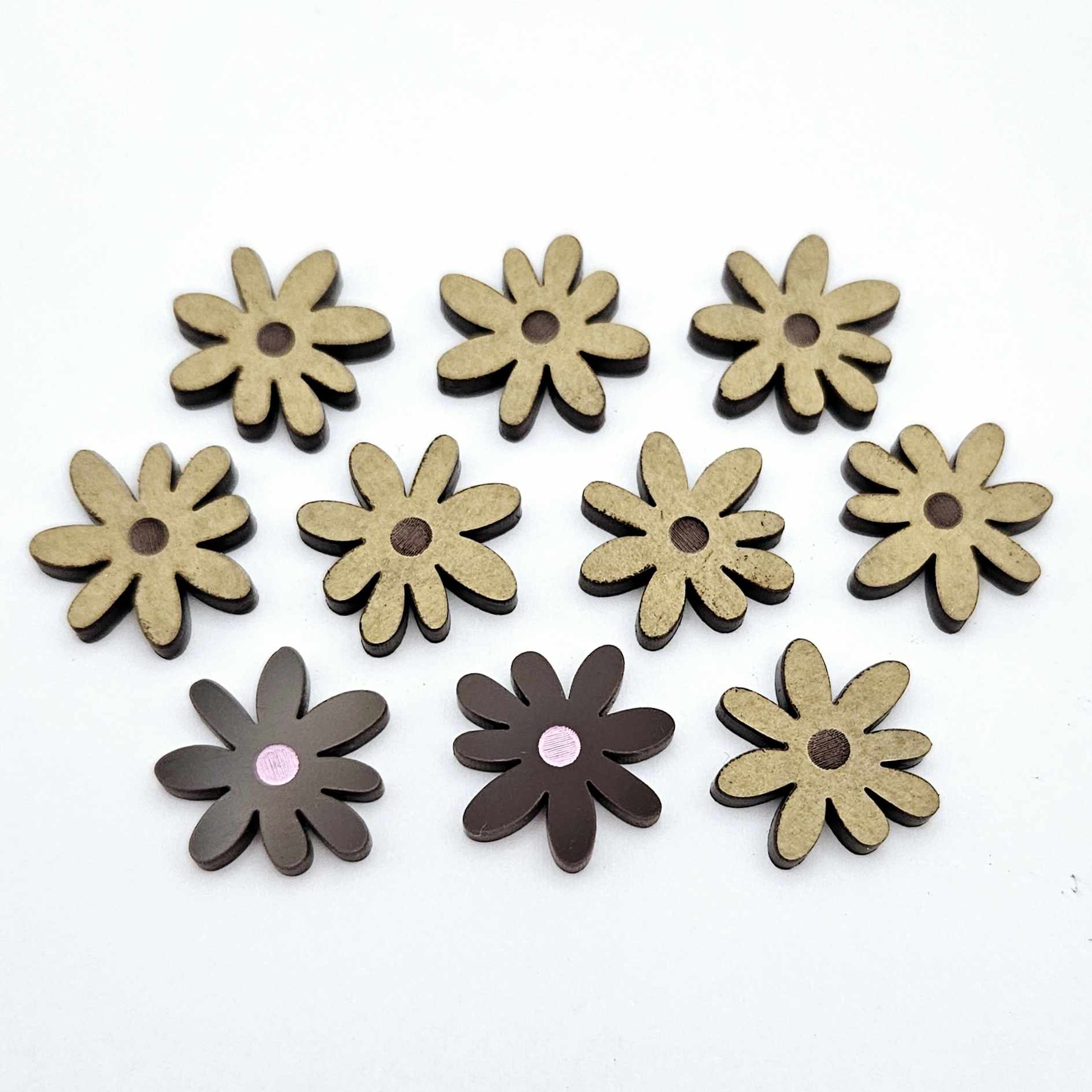 17mm chocolate brown acrylic flower stud blanks with engraved centre detail, one pair paint filled light pink and peeled, with additional pieces shown with protective film on