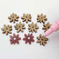 Port wine (Maroon) acrylic flower stud blanks showing paint filled light pink example and unpainted pieces with protective film, pictured with a light pink Posca paint pen