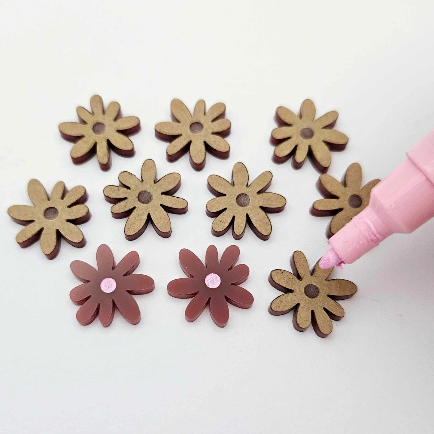 Port wine (Maroon) acrylic flower stud blanks showing paint filled light pink example and unpainted pieces with protective film, pictured with a light pink Posca paint pen