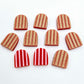Red striped arch stud blanks with engraved stripes, one pair paint filled light pink and peeled, with additional unpainted pieces shown with protective film on