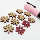 Port wine (Maroon) acrylic flower stud blanks showing paint filled light pink example and unpainted pieces with protective film, pictured with a light pink Posca paint pen