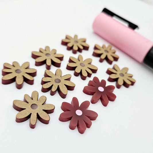 Port wine (Maroon) acrylic flower stud blanks showing paint filled light pink example and unpainted pieces with protective film, pictured with a light pink Posca paint pen