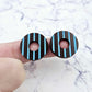 22mm chocolate brown striped hoop acrylic stud blanks paint filled with light blue, shown on a finger for size reference and finished look