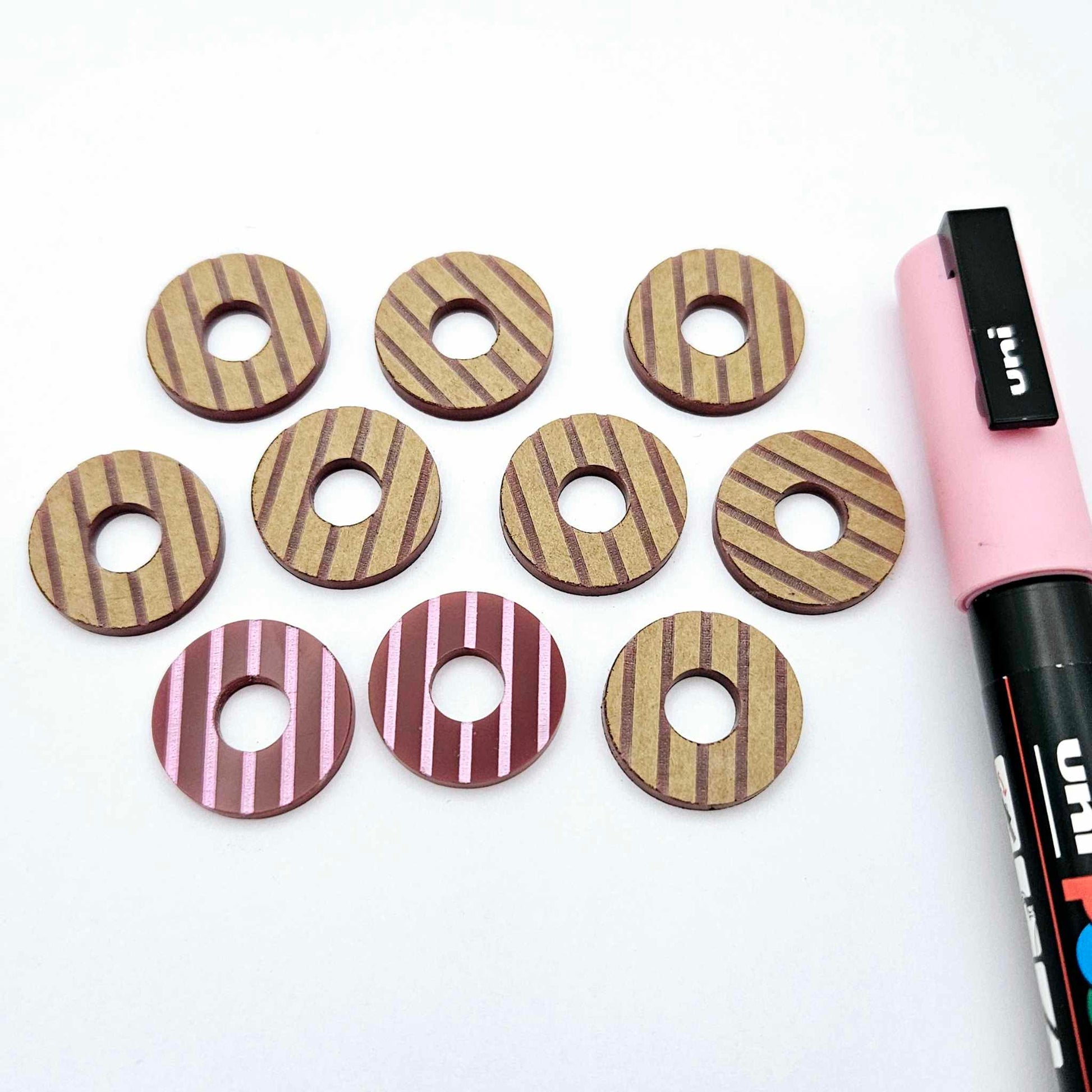 22mm port wine (burgundy) striped acrylic hoop stud blanks showing paint filled example and unpainted pieces with protective film, pictured with a light pink Posca paint pen