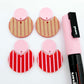 Nested circle dangle blanks showing one pair paint filled light pink and peeled, with another pair unpainted and with protective film on, pictured with a pink Posca paint pen