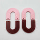 Layered U dangle blanks in pastel pink and port wine (burgundy) acrylic, one pair shown unassembled laying flat with matching U-shaped pieces