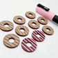 22mm port wine (burgundy) striped acrylic hoop stud blanks showing paint filled example and unpainted pieces with protective film, pictured with a light pink Posca paint pen