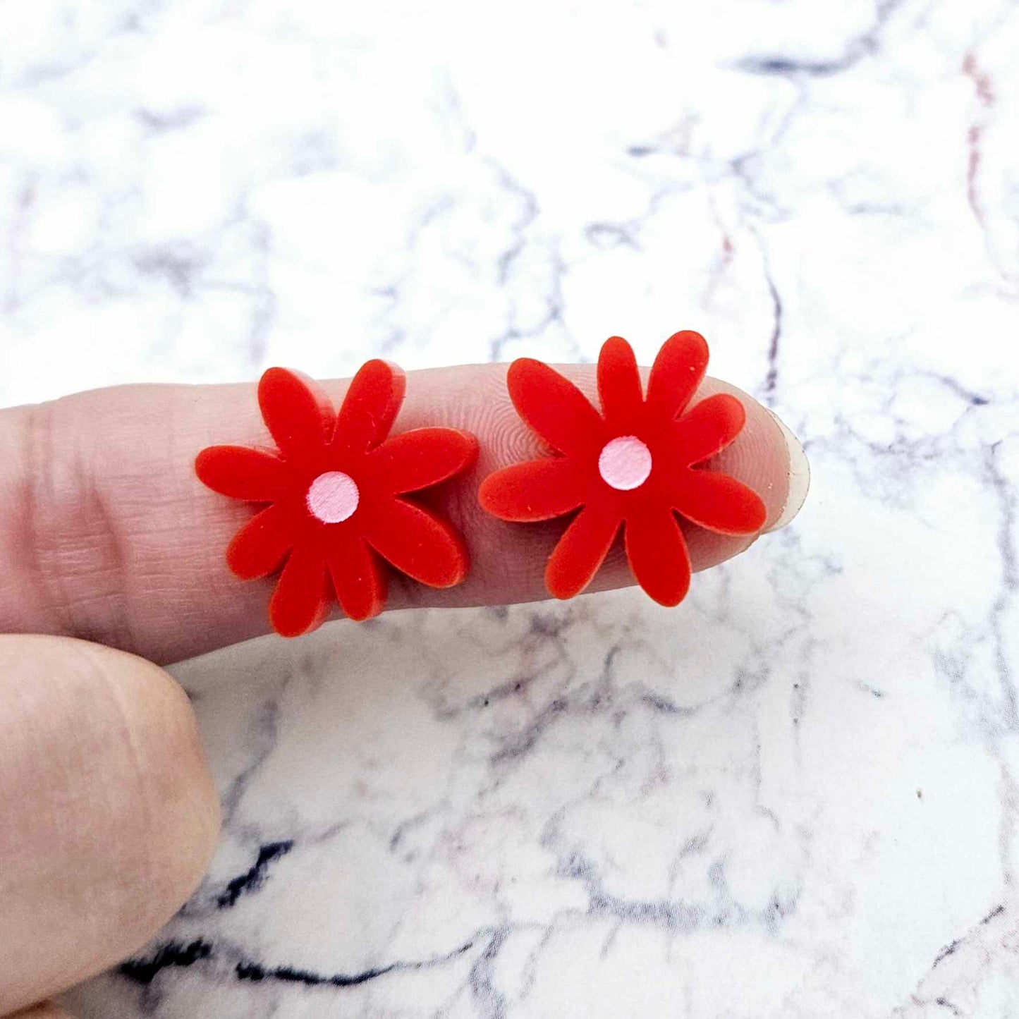 17mm red acrylic flower stud blanks with engraved centre detail, one pair paint filled light pink shown on finger for size reference