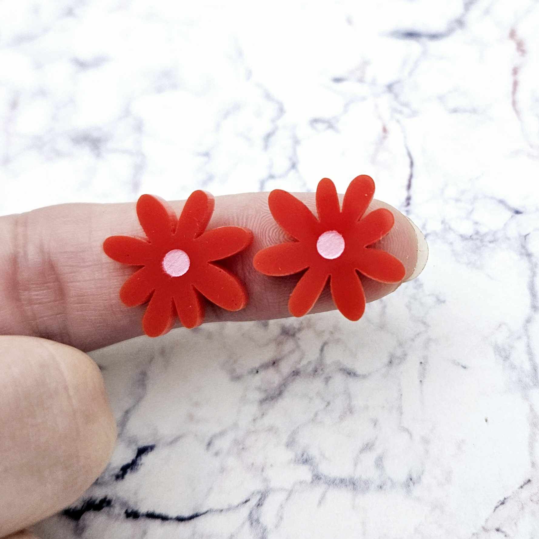 17mm red acrylic flower stud blanks with engraved centre detail, one pair paint filled light pink shown on finger for size reference