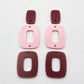 Layered rectangle dangle blanks in port wine and pastel pink, one pair shown unassembled laying flat with rectangle topper and two hoop pieces