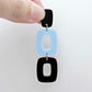 Assembled layered rectangle dangle earring in chocolate brown and pastel blue acrylic, three-piece geometric statement design