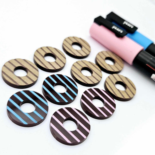 22mm chocolate brown striped acrylic hoop stud blanks showing paint filled examples and unpainted pieces with protective film, pictured with a light pink and light blue Posca paint pen