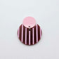 Nested circle acrylic dangle earring with pastel pink topper and port wine striped base, paint filled light pink and fully assembled to show finished look