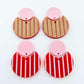 Nested circle dangle blanks showing one pair paint filled light pink and peeled, with another pair unpainted and with protective film on