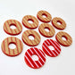 22mm red acrylic striped hoop stud blanks with engraved stripes, one pair paint filled light pink and peeled, with additional unpainted pieces shown with protective film on