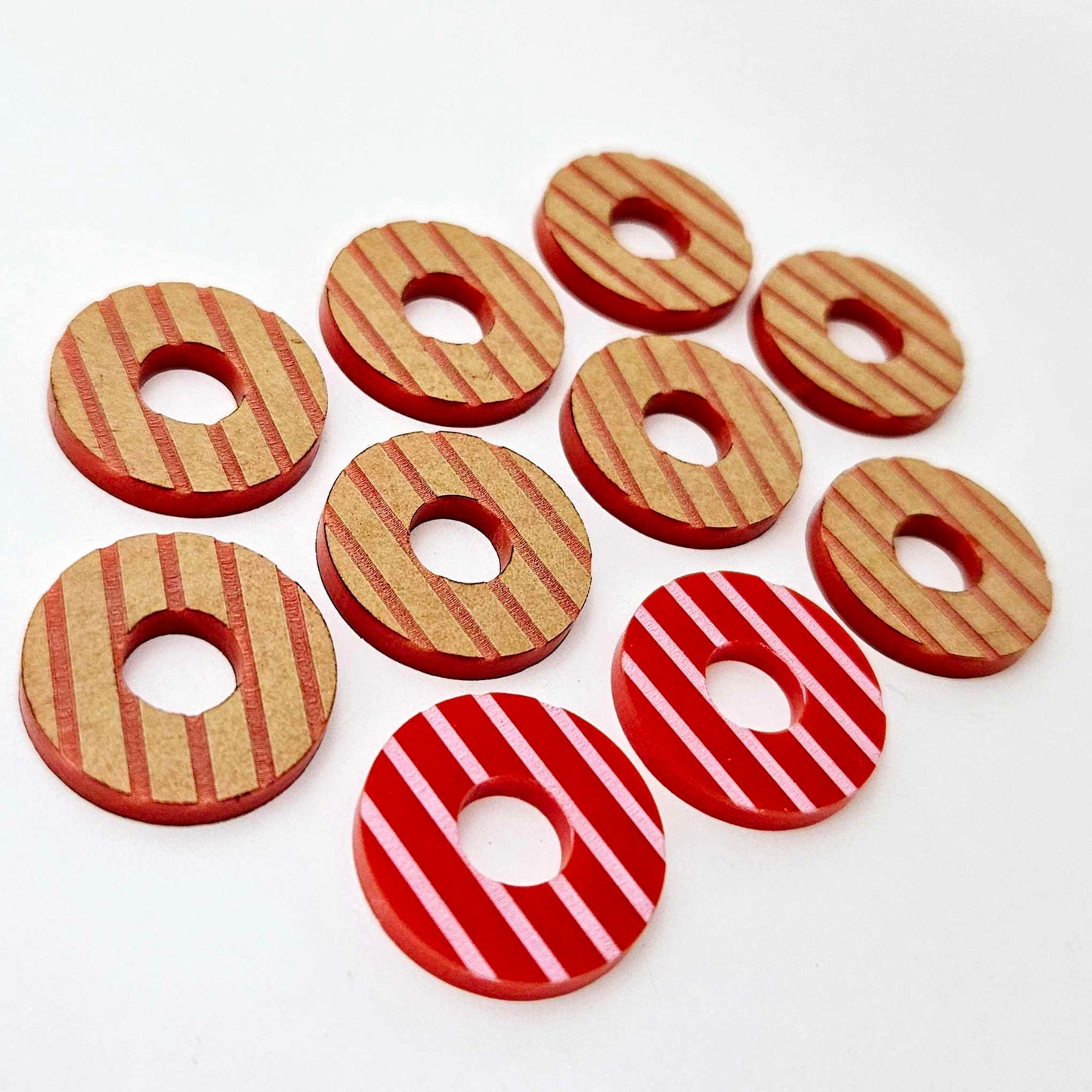 22mm red acrylic striped hoop stud blanks with engraved stripes, one pair paint filled light pink and peeled, with additional unpainted pieces shown with protective film on
