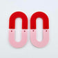 Layered U dangle blanks in pastel pink and red acrylic, one pair shown unassembled laying flat with matching U-shaped pieces