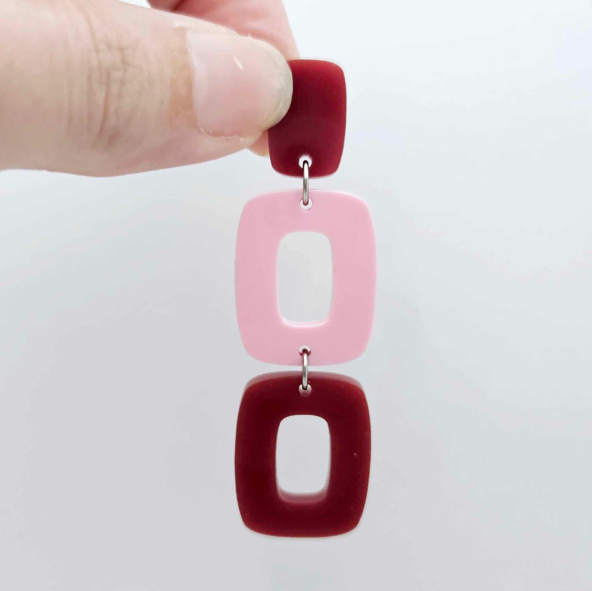 Assembled layered rectangle dangle earring in port wine and pastel pink acrylic, three-piece geometric statement design