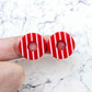 22mm red striped hoop acrylic stud blanks paint filled with light pink, shown on a finger for size reference and finished look