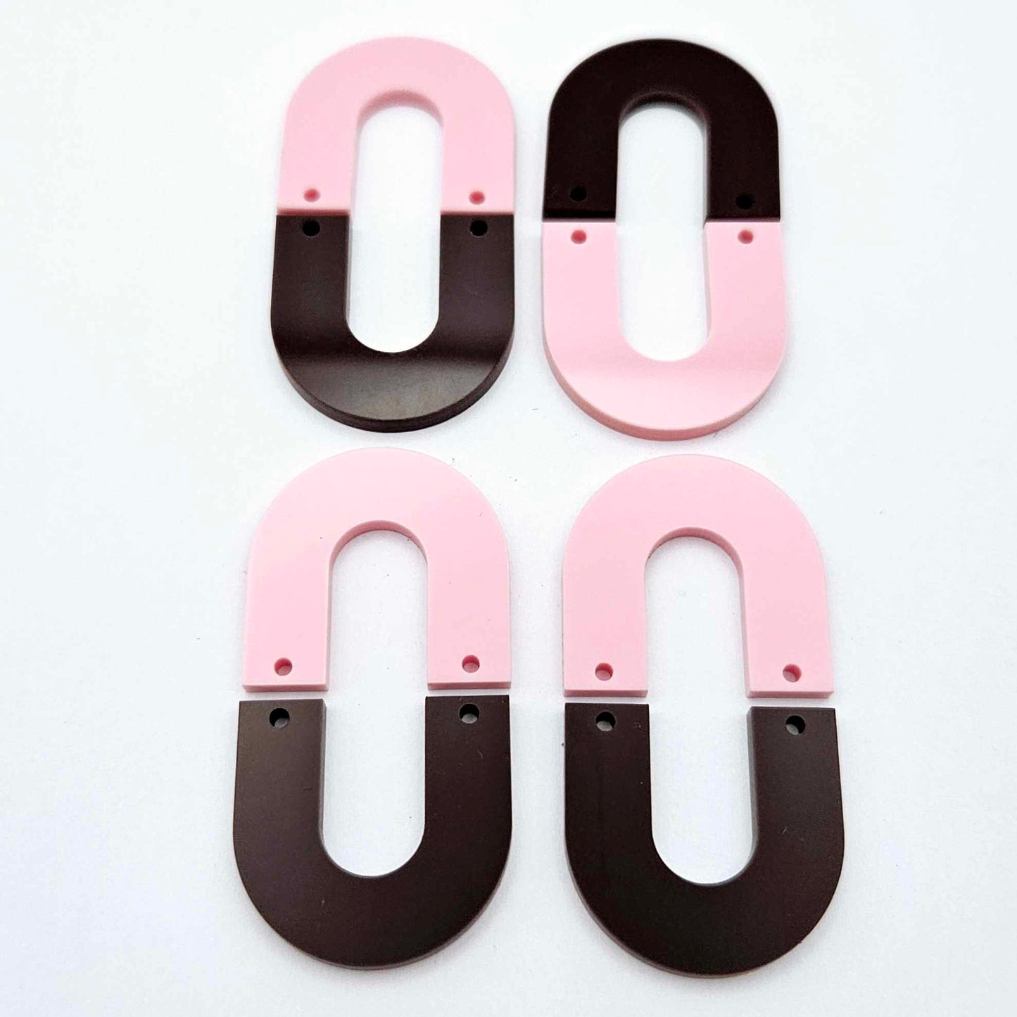 Layered U dangle blanks in pastel pink and chocolate brown acrylic, two pairs shown unassembled laying flat with matching U-shaped pieces