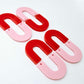 Layered U dangle blanks in pastel pink and red acrylic, two pairs shown unassembled laying flat with matching U-shaped pieces