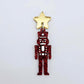 Assembled 40mm nutcracker Christmas dangle earrings in red glitter acrylic with engraved detail paint filled white