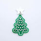 One solid green cookie Christmas tree dangle with engraved icing details paint filled in light pink and white, assembled with a 16mm white star topper