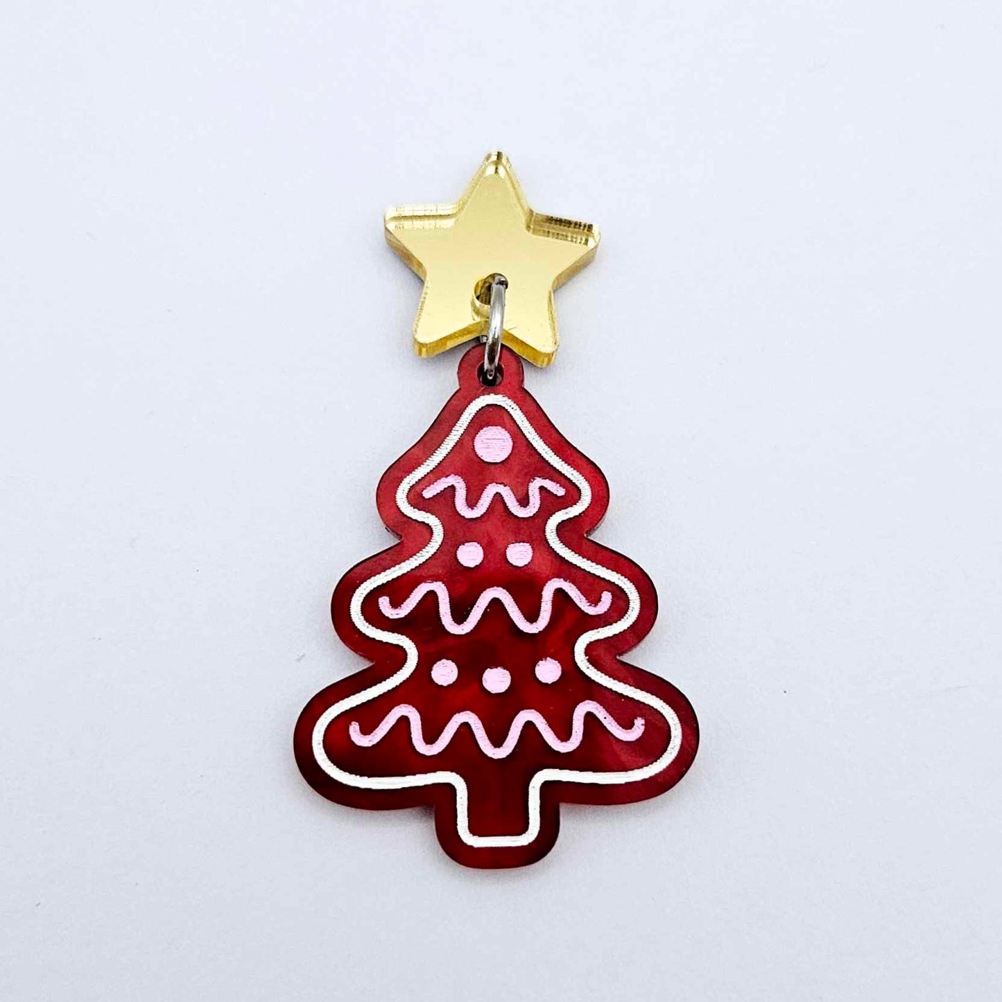 One deep red marble cookie Christmas tree dangle with engraved icing details paint filled in light pink and white, assembled with a 16mm gold mirror star topper