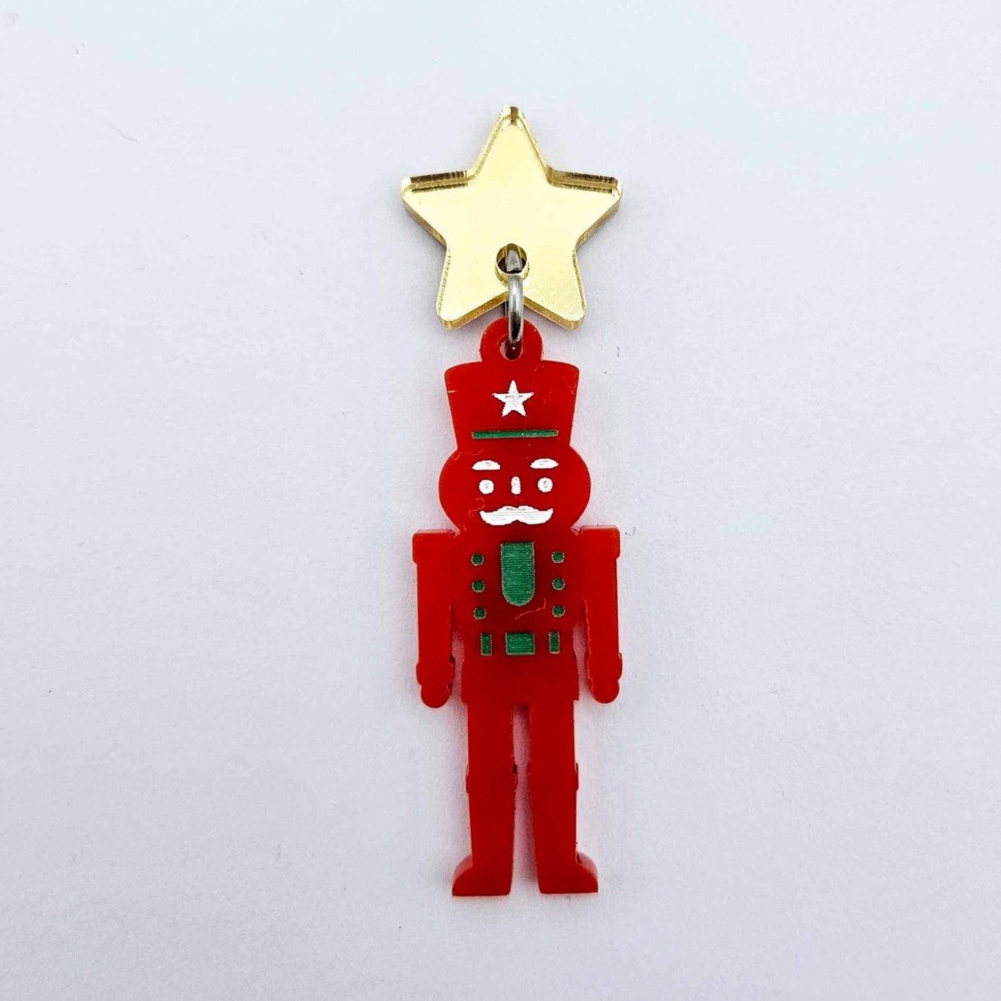 Assembled 40mm nutcracker Christmas dangle earrings in red acrylic with engraved detail paint filled with green and white