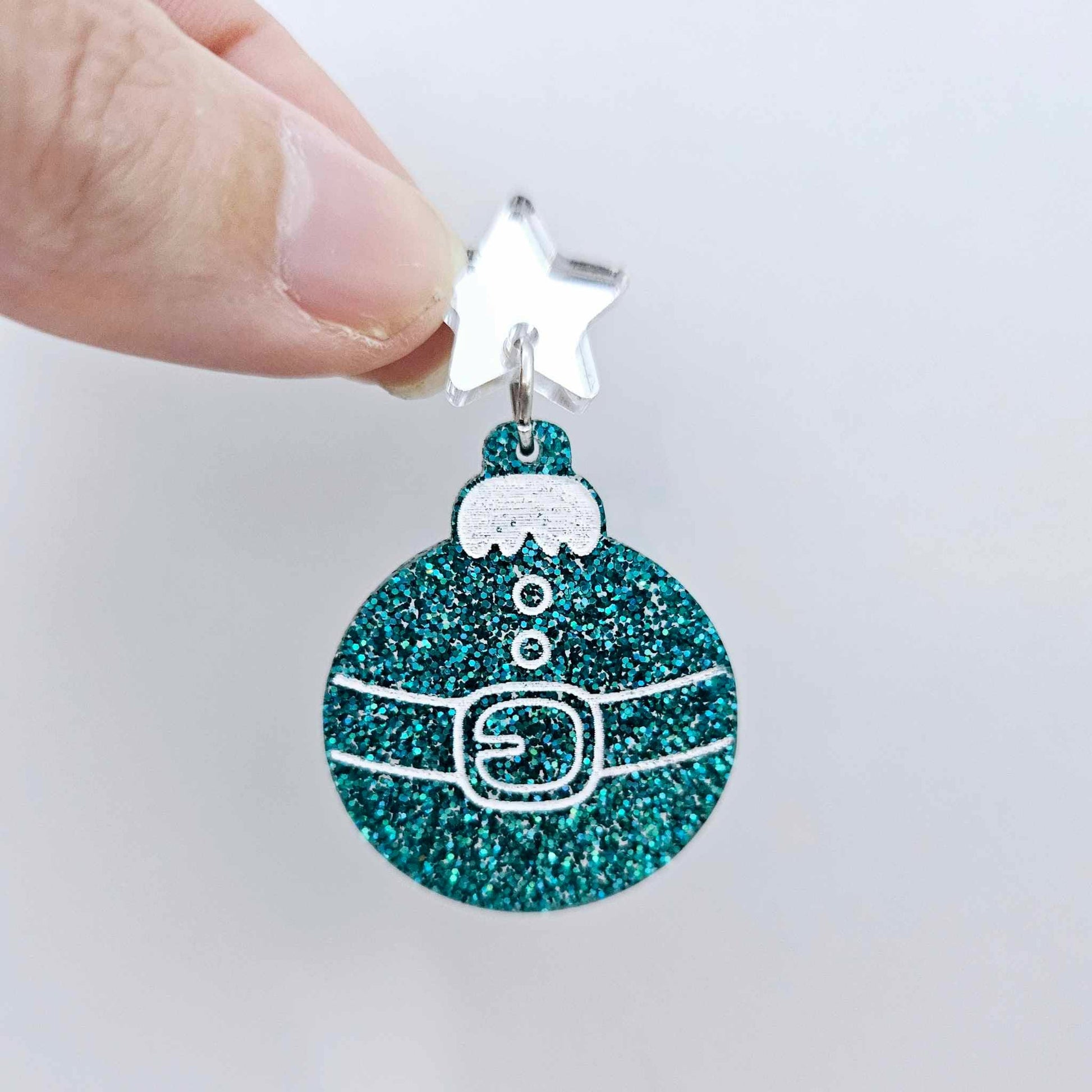 One teal glitter Santa bauble dangle with engraved Santa belt and button details paint filled white, assembled with a 16mm silver mirror star topper