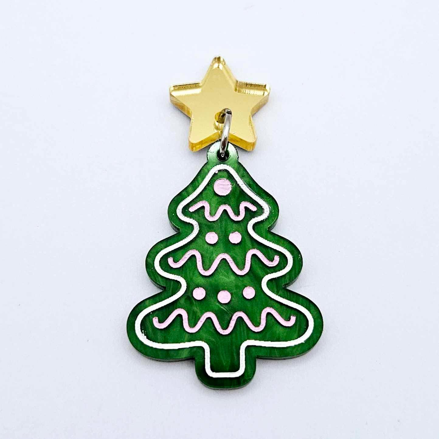 One green marble cookie Christmas tree dangle with engraved icing details paint filled in light pink and white, assembled with a 16mm gold mirror star topper