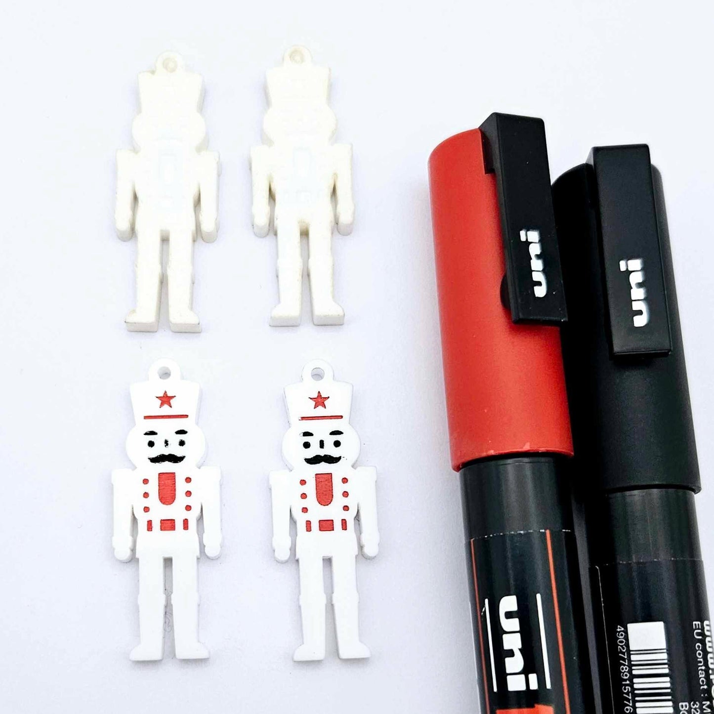 40mm nutcracker Christmas dangle blanks with engraved paint-fill details shown in  white acrylic with black and red posca paint pens