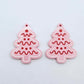 One pair of pastel pink cookie Christmas tree dangle blanks with engraved icing details paint filled in red and white, shown laying flat